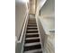 Stairway featuring hardwood stairs, neutral paint, and a white railing at 5538 Pineridge Ct, Forest Park, GA 30297