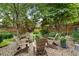 Serene backyard with brick patio, surrounded by lush greenery and shaded by mature trees, perfect for relaxation at 2350 Rosebrook Se Xing, Atlanta, GA 30339