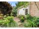 Backyard features a patio, a grilling area, surrounded by lush landscaping and a partial view of the home's exterior at 2350 Rosebrook Se Xing, Atlanta, GA 30339