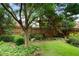 Beautiful backyard features a well-maintained lawn, privacy fence, mature trees, and peaceful surroundings at 2350 Rosebrook Se Xing, Atlanta, GA 30339