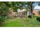 Spacious backyard features a brick patio, lush lawn, mature trees, and an inviting outdoor living space at 2350 Rosebrook Se Xing, Atlanta, GA 30339