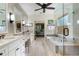 Bright bathroom featuring a large soaking tub, a glass-enclosed shower, and a vanity with double sinks at 2350 Rosebrook Se Xing, Atlanta, GA 30339