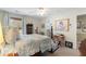 Bedroom featuring a four-poster bed with blue and white floral bedding, neutral walls, and a beige carpet at 2350 Rosebrook Se Xing, Atlanta, GA 30339