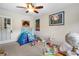 Bright bedroom featuring neutral walls, ceiling fan, crown molding, and an array of playful toys for children at 2350 Rosebrook Se Xing, Atlanta, GA 30339