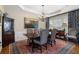 Formal dining room features a dark wood table with seating for six, a chandelier, and wainscoting at 2350 Rosebrook Se Xing, Atlanta, GA 30339