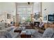 Spacious living room with a fireplace, large windows, and hardwood floors, ideal for Gathering gatherings at 2350 Rosebrook Se Xing, Atlanta, GA 30339