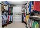 Spacious walk-in closet providing ample storage with built-in shelves, drawers, and multiple racks for hanging clothes at 2350 Rosebrook Se Xing, Atlanta, GA 30339