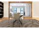 Bright dining area features modern glass table and chairs, wooden floors and windows for natural light at 468 Watson Ferry Dr, Forest Park, GA 30297