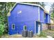 Rear exterior view of the blue home, highlighting the siding and utility connections at 468 Watson Ferry Dr, Forest Park, GA 30297