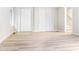 Living room features wood-look floors, white trim, a closet with white doors and staircase at 468 Watson Ferry Dr, Forest Park, GA 30297