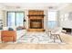 Bright living room with stone fireplace, modern furniture, and large windows for natural light at 468 Watson Ferry Dr, Forest Park, GA 30297