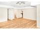 Open living room with hardwood floors, access to a bathroom and a view to the kitchen at 468 Watson Ferry Dr, Forest Park, GA 30297