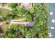 Aerial view of lakefront home surrounded by lush trees with a private dock and boat slips on the water at 6178 Lake Lanier Height Rd, Buford, GA 30518