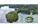 Picturesque aerial view featuring a wooded island with a modern boat dock on a tranquil lake at 6178 Lake Lanier Height Rd, Buford, GA 30518