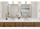 Double sink vanity with stone countertops and modern fixtures at 6178 Lake Lanier Height Rd, Buford, GA 30518