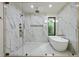 Luxurious bathroom with a large soaking tub, walk-in shower, and elegant marble tile at 6178 Lake Lanier Height Rd, Buford, GA 30518
