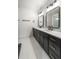Contemporary bathroom with dual vanities, sleek black fixtures, and a spacious shower with modern tile design at 6178 Lake Lanier Height Rd, Buford, GA 30518