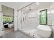 Elegant bathroom with a walk-in shower, soaking tub, and easy access to the main bedroom at 6178 Lake Lanier Height Rd, Buford, GA 30518