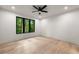 Light and bright bedroom with hardwood floors and large windows showing backyard view at 6178 Lake Lanier Height Rd, Buford, GA 30518