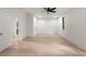 Spacious bedroom with hardwood floors, a ceiling fan, and ample natural light from the window at 6178 Lake Lanier Height Rd, Buford, GA 30518