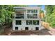 Stunning, contemporary two-story home featuring large windows and a spacious outdoor balcony overlooking the lush surroundings at 6178 Lake Lanier Height Rd, Buford, GA 30518