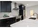 Modern kitchen with marble countertops, stainless steel appliances, and ample cabinet space at 6178 Lake Lanier Height Rd, Buford, GA 30518