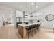 Spacious kitchen featuring a large island with barstool seating, modern lighting, and stainless steel appliances at 6178 Lake Lanier Height Rd, Buford, GA 30518