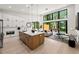Open kitchen and living room features a kitchen island and bright windows at 6178 Lake Lanier Height Rd, Buford, GA 30518