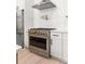 Stainless steel range with pot filler against herringbone backsplash at 6178 Lake Lanier Height Rd, Buford, GA 30518