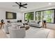 Bright living room featuring large windows with natural light and stylish neutral furniture at 6178 Lake Lanier Height Rd, Buford, GA 30518