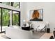 Living room view of trees and bright light from floor-to-ceiling windows at 6178 Lake Lanier Height Rd, Buford, GA 30518