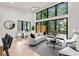 Bright living room with floor to ceiling windows, modern furnishings and light wood floors at 6178 Lake Lanier Height Rd, Buford, GA 30518