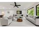 Spacious living room featuring large windows offering natural light and modern decor at 6178 Lake Lanier Height Rd, Buford, GA 30518