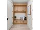 Convenient mudroom with built-in storage, seating, and a neutral color palette at 6178 Lake Lanier Height Rd, Buford, GA 30518