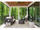 Covered patio featuring a wicker furniture set, ceiling fan, and scenic outdoor views at 6178 Lake Lanier Height Rd, Buford, GA 30518