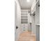 Bright walk-in closet with built-in shelving, drawers, and hanging rods, offering ample storage space at 6178 Lake Lanier Height Rd, Buford, GA 30518