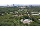 Aerial view captures community nestled among lush trees, highlighting city skyline at 717 Lenox Ln, Atlanta, GA 30324