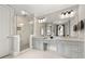 Bathroom featuring a glass-enclosed shower, double vanity, and modern lighting at 717 Lenox Ln, Atlanta, GA 30324