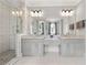 Bathroom featuring a glass-enclosed shower, double vanity, and modern lighting at 717 Lenox Ln, Atlanta, GA 30324