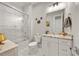 Bathroom featuring granite countertops, white cabinets, and a glass-enclosed tub-shower at 717 Lenox Ln, Atlanta, GA 30324
