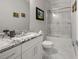 Bright bathroom featuring granite countertops, white cabinets, and a glass-enclosed tub-shower at 717 Lenox Ln, Atlanta, GA 30324