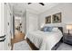 Comfortable bedroom with hardwood floors, a ceiling fan, and an en-suite bath at 717 Lenox Ln, Atlanta, GA 30324
