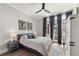 Bedroom with large windows, ceiling fan, hardwood floors, and decorative artwork at 717 Lenox Ln, Atlanta, GA 30324