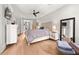 Primary bedroom with hardwood floors, a ceiling fan, and an en-suite bath at 717 Lenox Ln, Atlanta, GA 30324