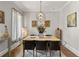 Dining room features a modern chandelier, neutral tones, and natural light at 717 Lenox Ln, Atlanta, GA 30324