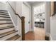 Welcoming entryway with hardwood floors and staircase leading to a kitchen view, creating a warm and inviting transition space at 717 Lenox Ln, Atlanta, GA 30324