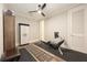Home gym features rowing machine, fitness storage cabinet, and wood flooring at 717 Lenox Ln, Atlanta, GA 30324