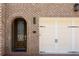 Charming brick home with arched doorway, decorative glass door and attached garage at 717 Lenox Ln, Atlanta, GA 30324