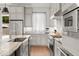 Modern kitchen featuring stainless steel appliances, light wood floors, and gray cabinets, complete with ample counter space and natural light at 717 Lenox Ln, Atlanta, GA 30324