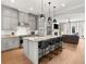 Bright kitchen features shaker cabinets, stainless appliances, and island with seating at 717 Lenox Ln, Atlanta, GA 30324